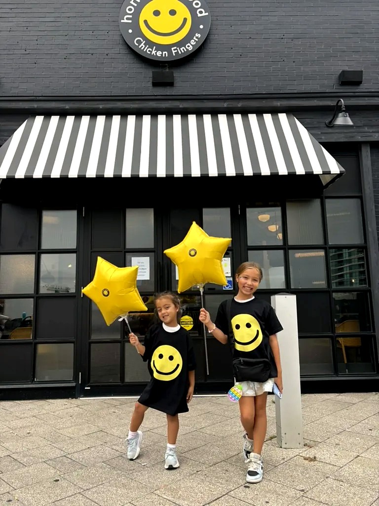 Young guests with Honestly Good balloons outside the Sherway Gardens restaurant